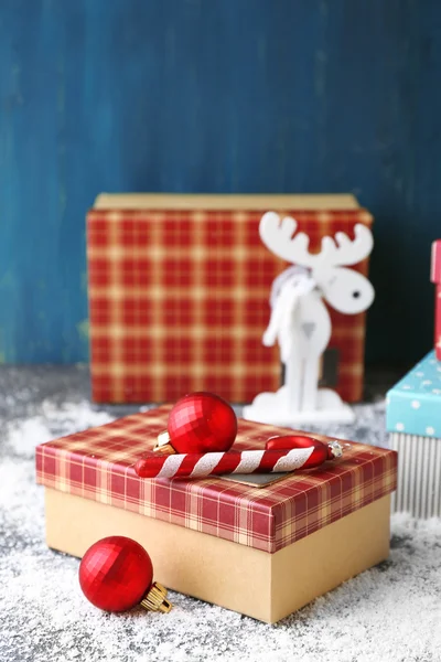 Christmas gifts on color wooden background — Stock Photo, Image