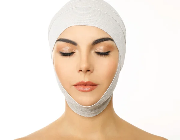 Young beautiful woman with an elastic bandage on her head, isolated on white — Stock Photo, Image