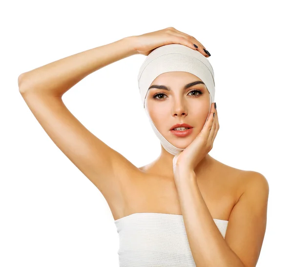 Young beautiful woman with an elastic bandage on her head, isolated on white — Stock Photo, Image