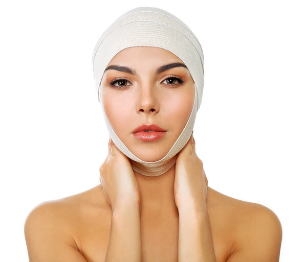 Young beautiful woman with an elastic bandage on her head, isolated on white