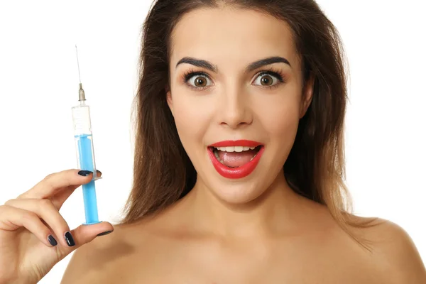 Young emotional woman holding syringe, isolated on white — Stock Photo, Image