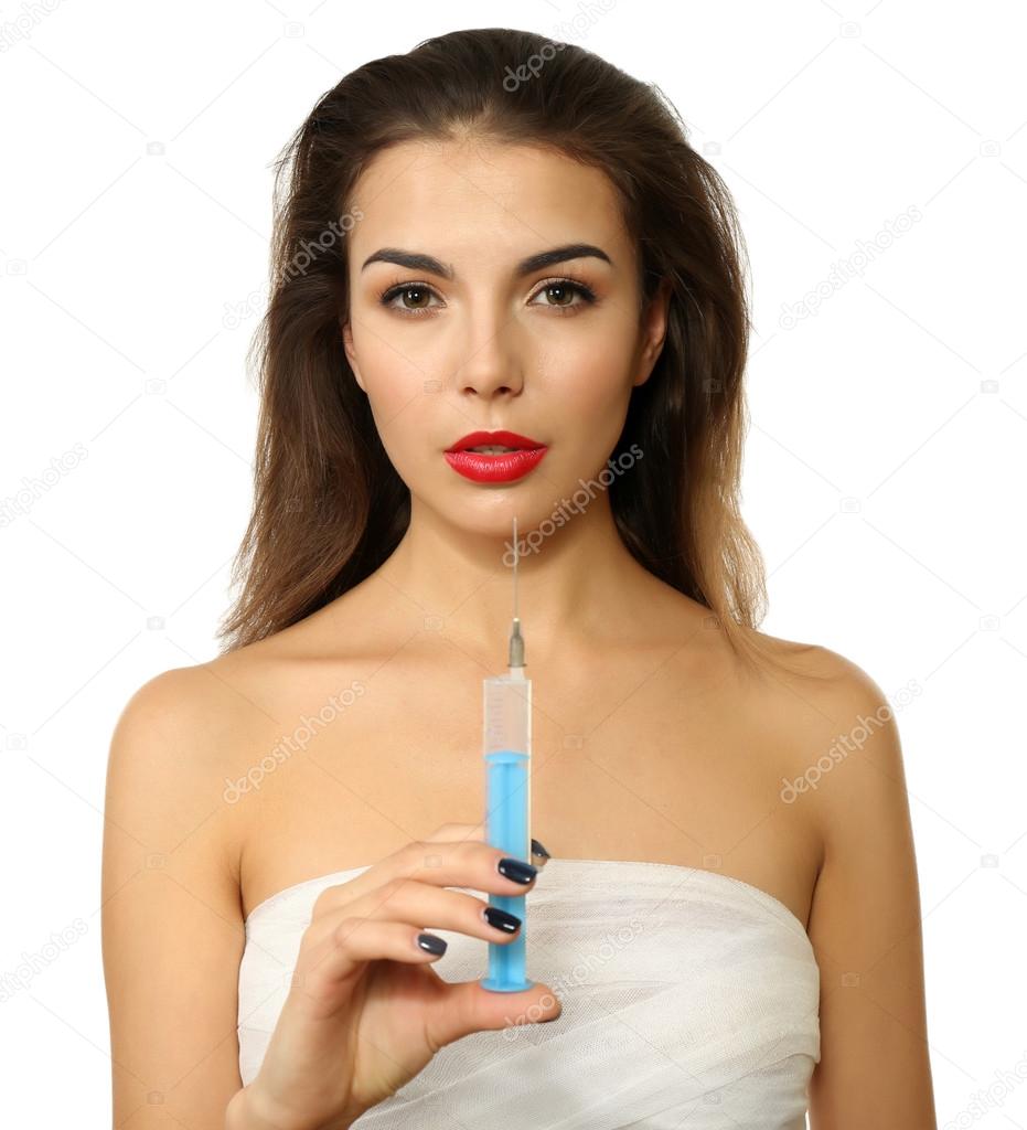 Young beautiful woman with a gauze bandage on her chest, holding syringe, isolated on white