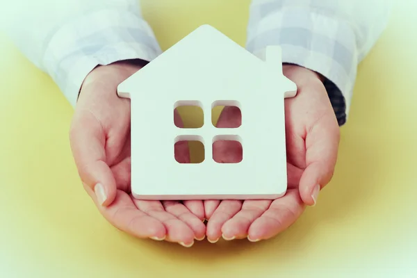 Vrouwelijke handen met huis — Stockfoto