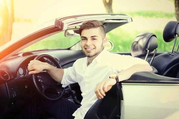 Young man in cabriolet — Stock Photo, Image