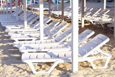 Kum plajındaki plastik şezlong 