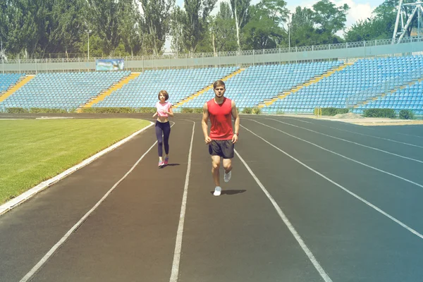 Young people jogging on stadium — Stock Photo, Image