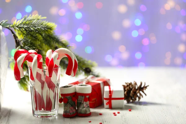 Christmas Candy Canes in glass on table on light background — Stock Photo, Image