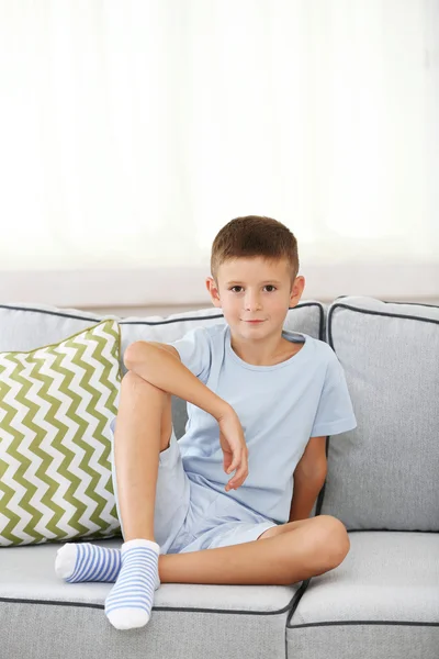 Little boy sitting on sofa — Stock Photo, Image