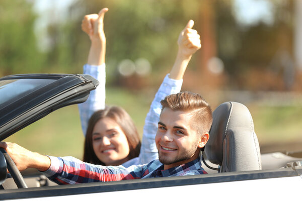 Couple in cabriolet car