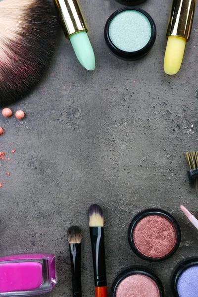 Decorative cosmetics laying out as a frame on grey background — Stock Photo, Image