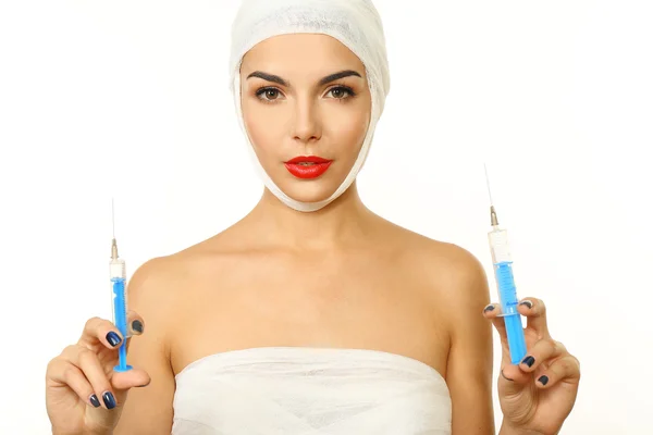 Woman with a gauze bandage holding syringe — Stock Photo, Image