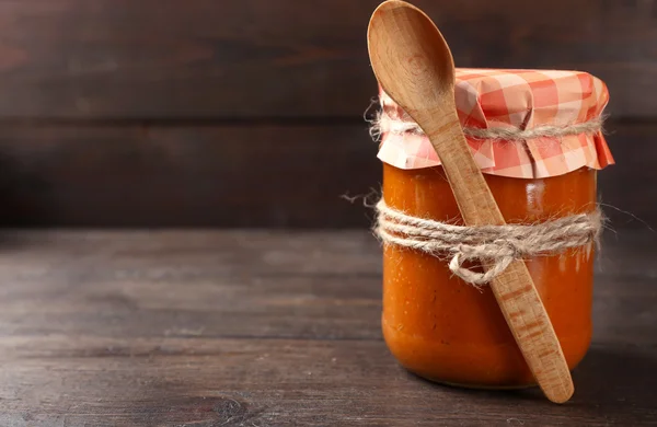 Jar with squash caviar on wooden background — Stock Photo, Image