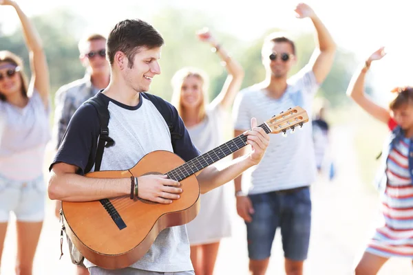Attractive Young Man Plays Guitar Dancing Friends Outdoors — Stock Photo, Image