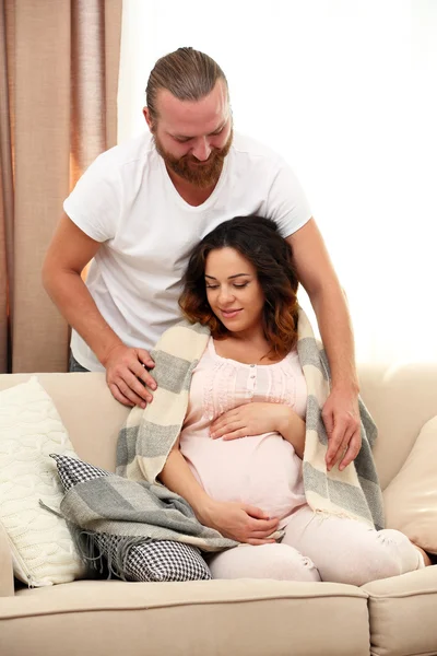 Hombre guapo cuida de su encantadora mujer embarazada — Foto de Stock