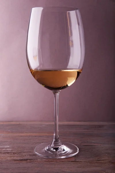 Glass of white wine on wooden table — Stock Photo, Image