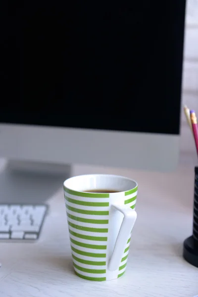 Taza de té a rayas en la mesa moderna —  Fotos de Stock