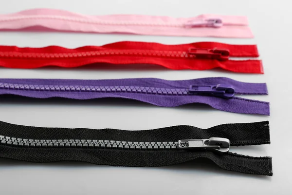 Colourful collection of zippers isolated on white — Stock Photo, Image