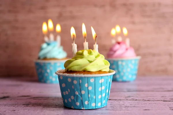 Tasty cupcakes with candles — Stock Photo, Image