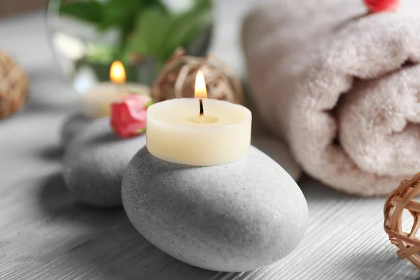 Composition of flowers, candles and stones — Stock Photo, Image