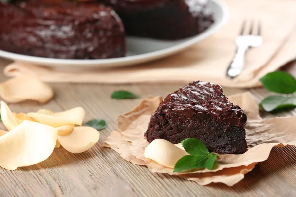 Piece of chocolate cake decorated with flowers — Stock Photo, Image