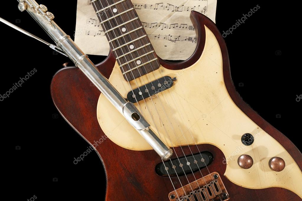 Flute, electric guitar and note sheets — Stock Photo © belchonock 89575518