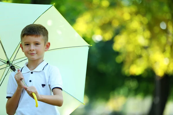 Αγόρι, υπό μεγάλη ομπρέλα κρεμώδη — Φωτογραφία Αρχείου