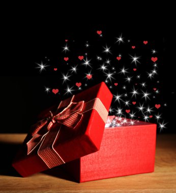 Open gift box and small hearts