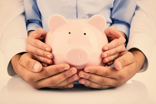 Hands holding piggy bank — Stock Photo, Image