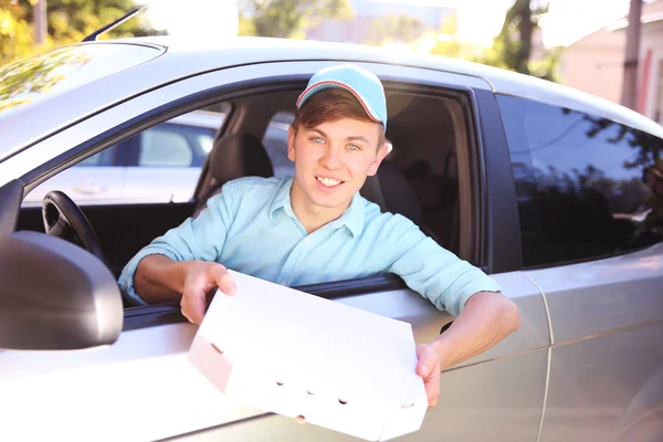 Pizza delivery boy in car — Stock Photo, Image