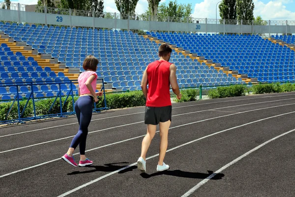 Young people jogging on stadium — Stock Photo, Image