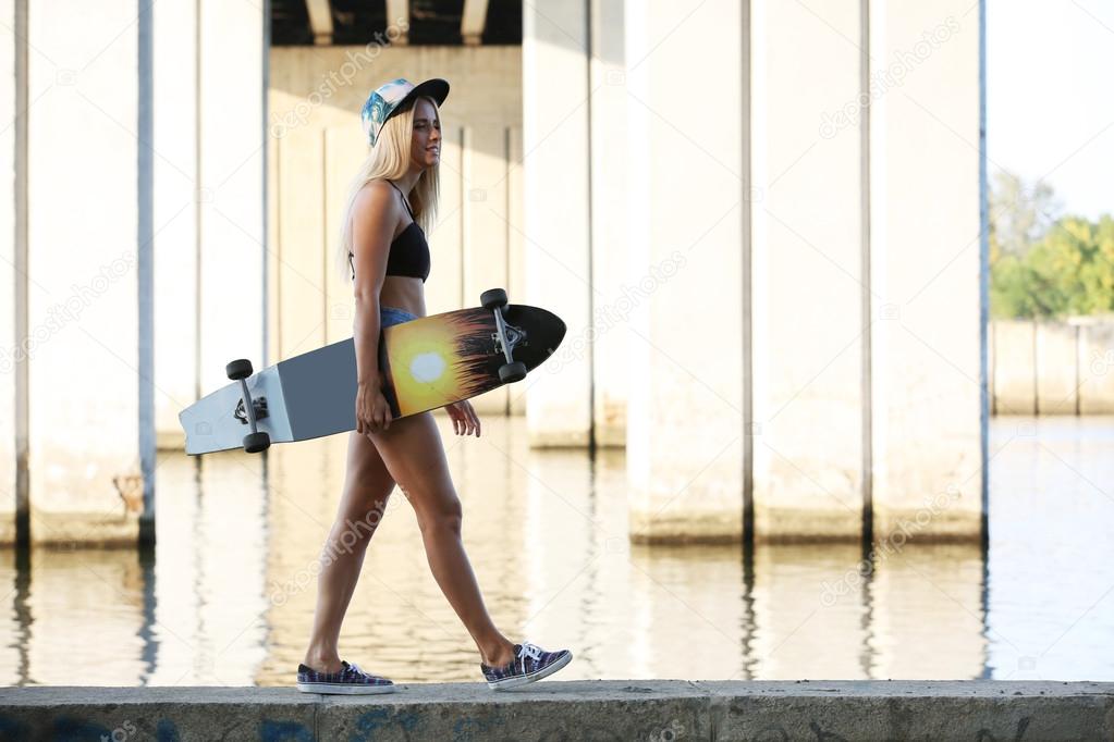 Young woman with skating board 