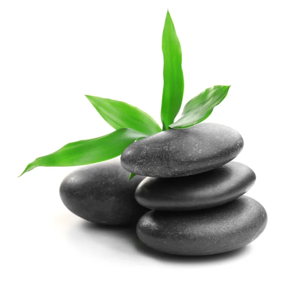 Stack of stones and a green flower, isolated on white. Spa relaxation concept — Stock Photo, Image