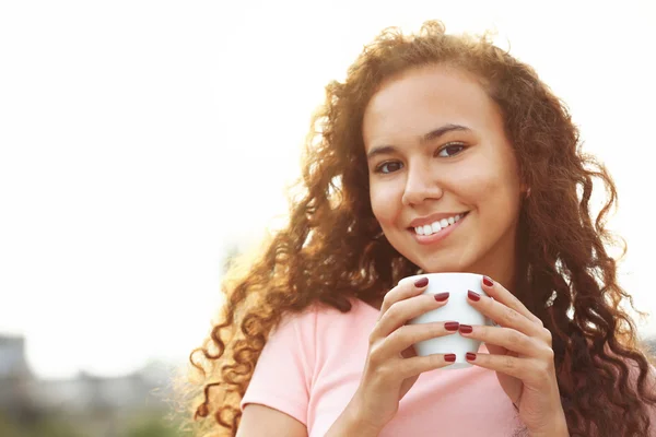 Nahaufnahme Porträt einer hübschen jungen Frau im rosa Kleid, die auf der Sommerterrasse Kaffee trinkt — Stockfoto