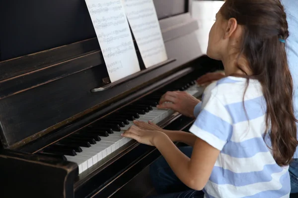 Вчителька і дівчина грають на піаніно — стокове фото