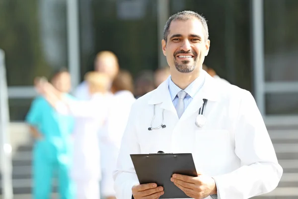 Happy Doctor Holds Clipboard Hands Medical Stuff Standing Clinic Entrance — Stock Photo, Image