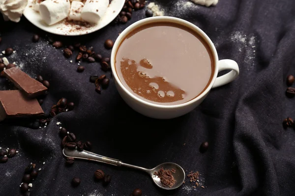 Taza de café con dulces sobre un mantel negro — Foto de Stock