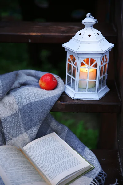 Lantern with candle on wooden stairs, on mountains background — Stock Photo, Image