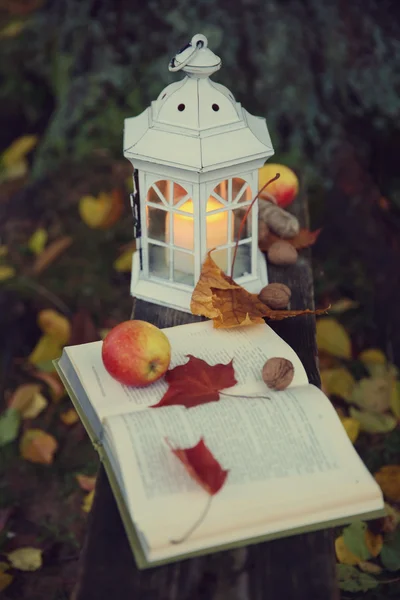 Lantern with candle on old bench — Stock Photo, Image