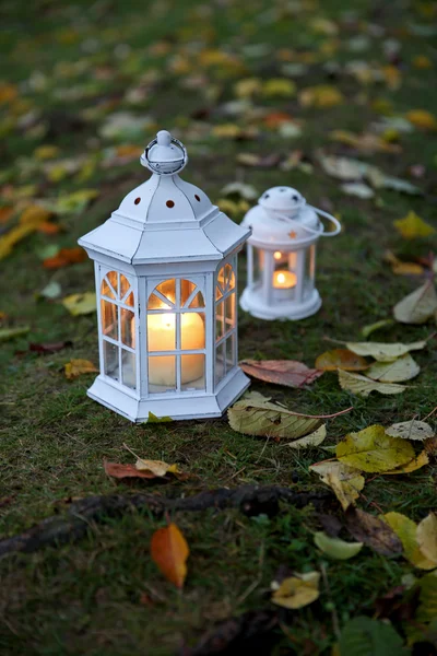 Lanterns with candles on grass background — Stock Photo, Image