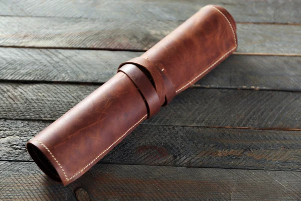 Leather case on wooden background — Stock Photo, Image