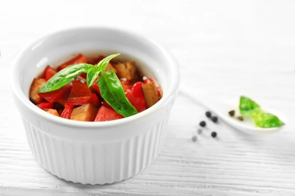 Ratatouille végétarienne savoureuse à base d'aubergines, courges, tomates dans un bol sur fond de table en bois — Photo