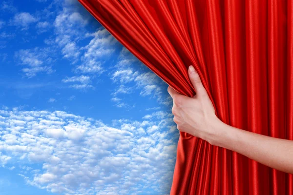 Hand opens curtain on sky — Stock Photo, Image