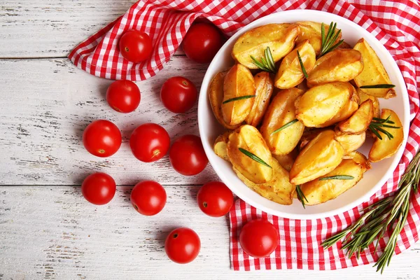 Baked potato wedges on wooden table, closeup — Stock Photo, Image