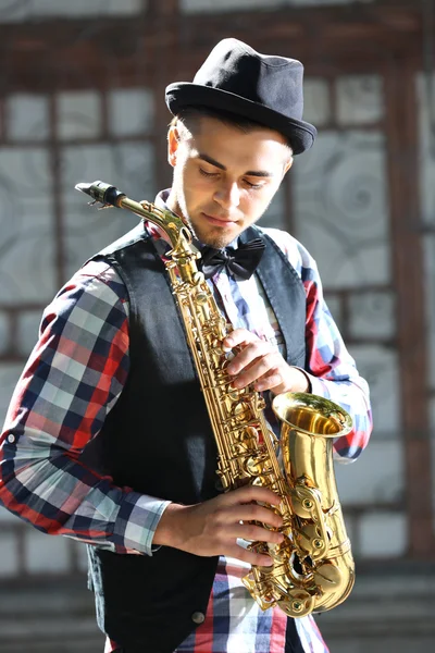 Mladý muž hraje saxofon — Stock fotografie