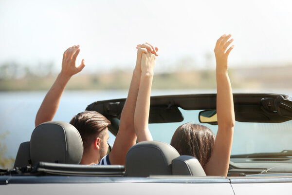 Couple in cabriolet car