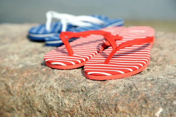 Bright flip-flops on stone, nature background — Stock Photo, Image