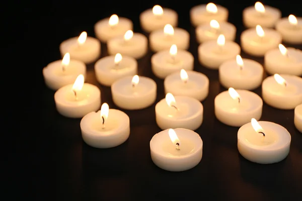 Alight candles in row — Stock Photo, Image