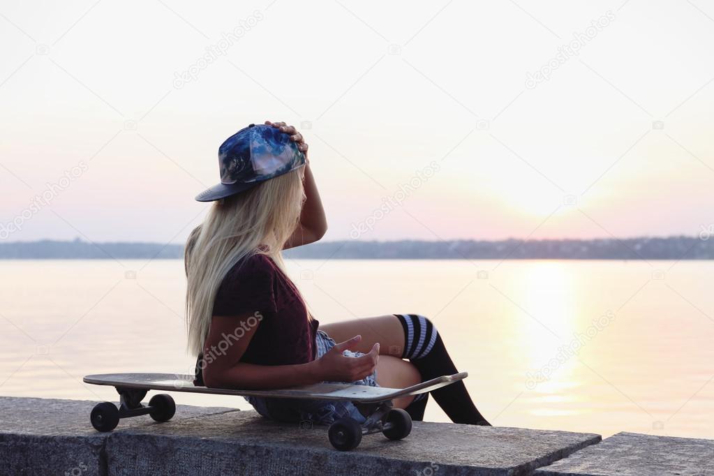 Young woman with skating board 