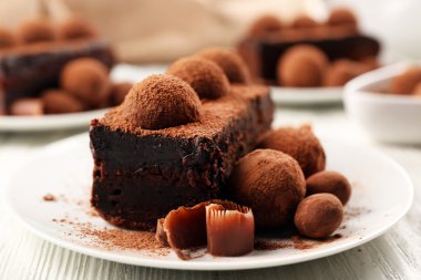 Slices of chocolate cake with a truffle on plate closeup clipart
