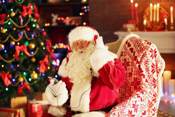 Santa Claus sitting with headphones — Stock Photo, Image